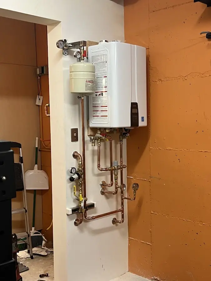 Plumbing technician inspecting water heater connections in Snoqualmie